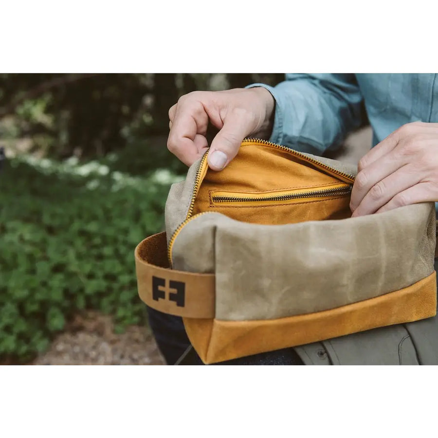 a person holding a brown and tan bag