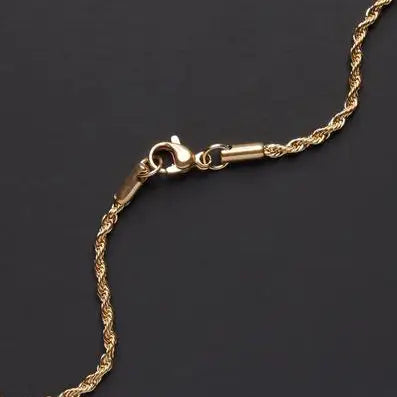 a gold chain on a black surface