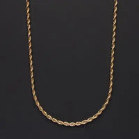 a gold rope necklace on a black background